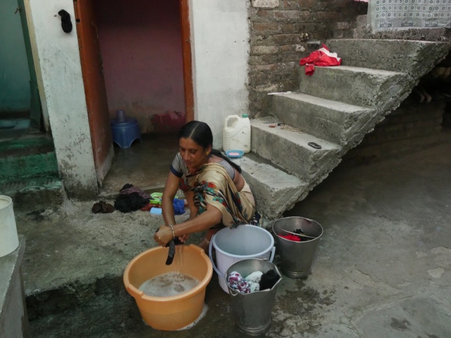 Lady doing the family wash by hand